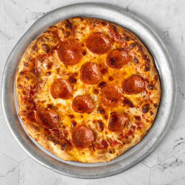 A freshly baked pepperoni pizza with melted cheese and a crispy crust on a metal pan.
